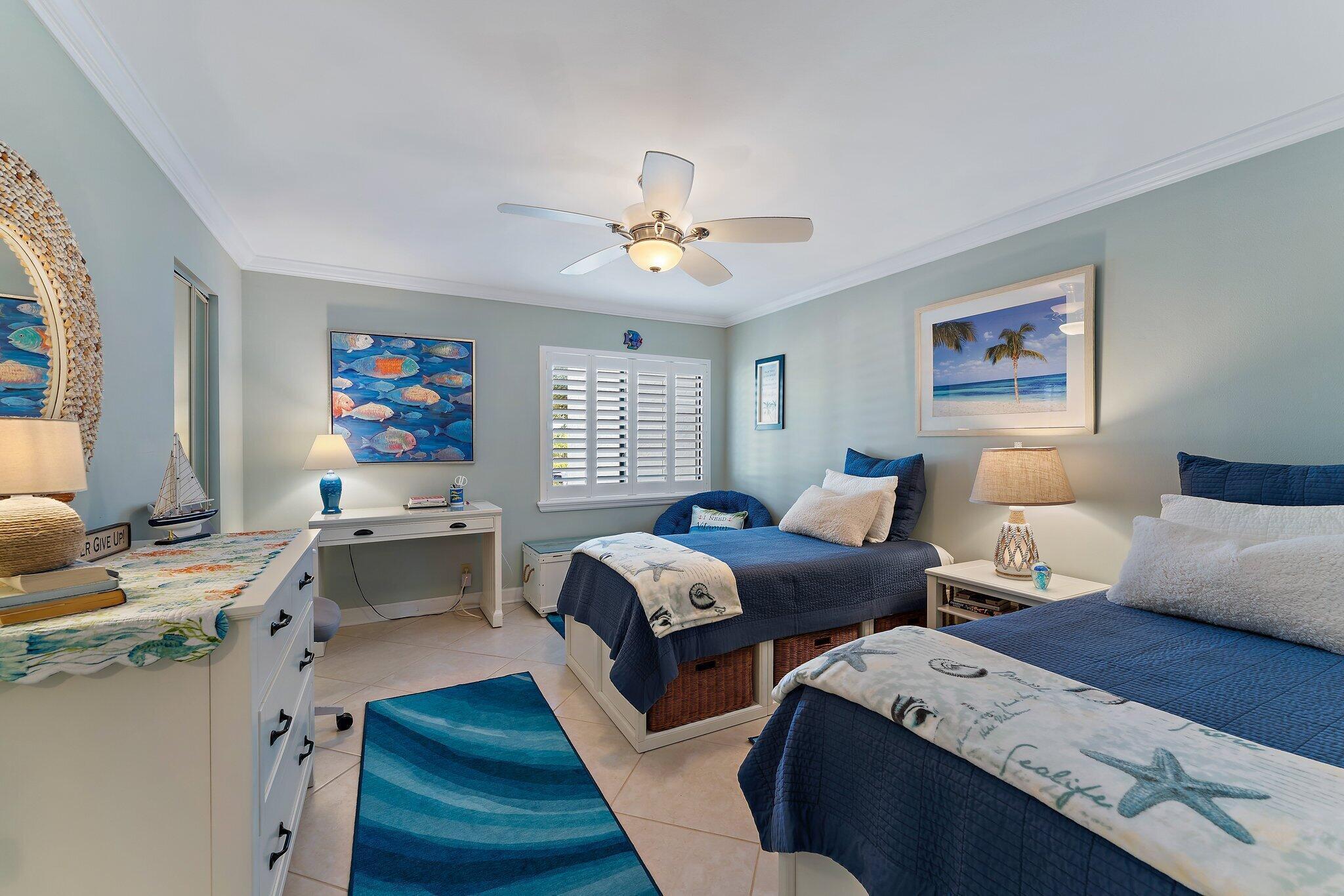 1605 Us-1, Unit B206 Jupiter, FL 33477 - Photo 21 of 35 a bedroom with two beds and a chandelier