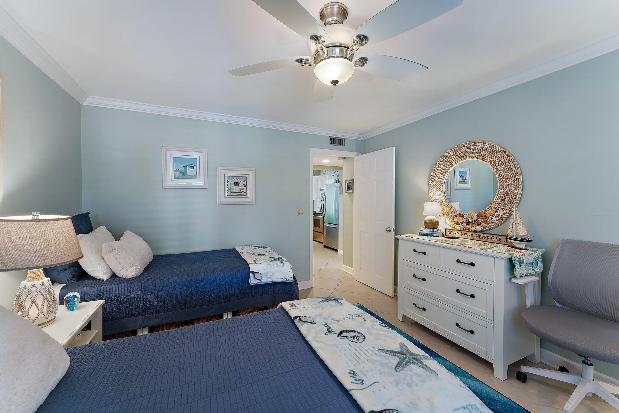 1605 Us-1, Unit B206 Jupiter, FL 33477 - Photo 23 of 35 a bedroom with a bed and wooden floor