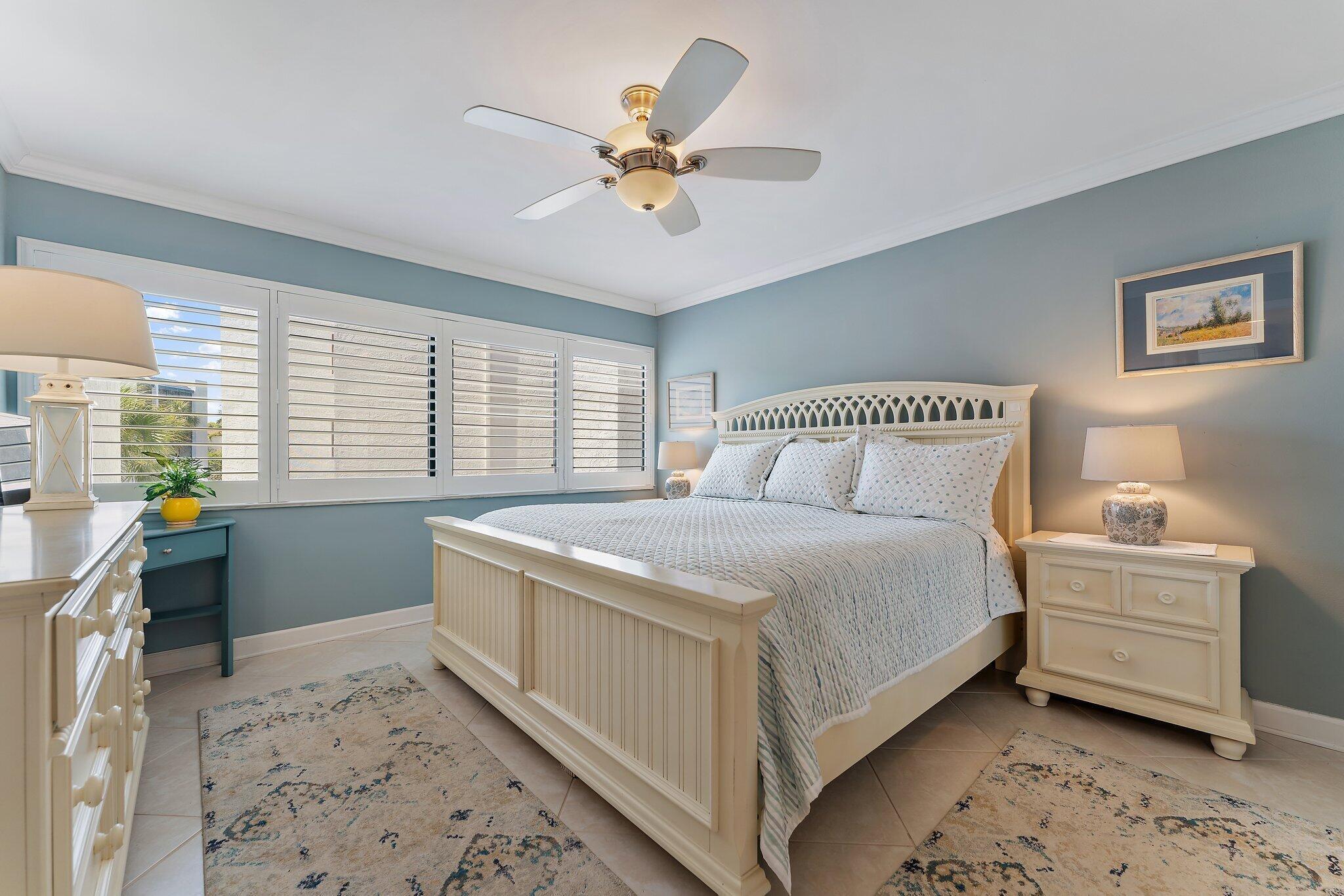 1605 Us-1, Unit B206 Jupiter, FL 33477 - Photo 24 of 35 a bedroom with a bed and a window