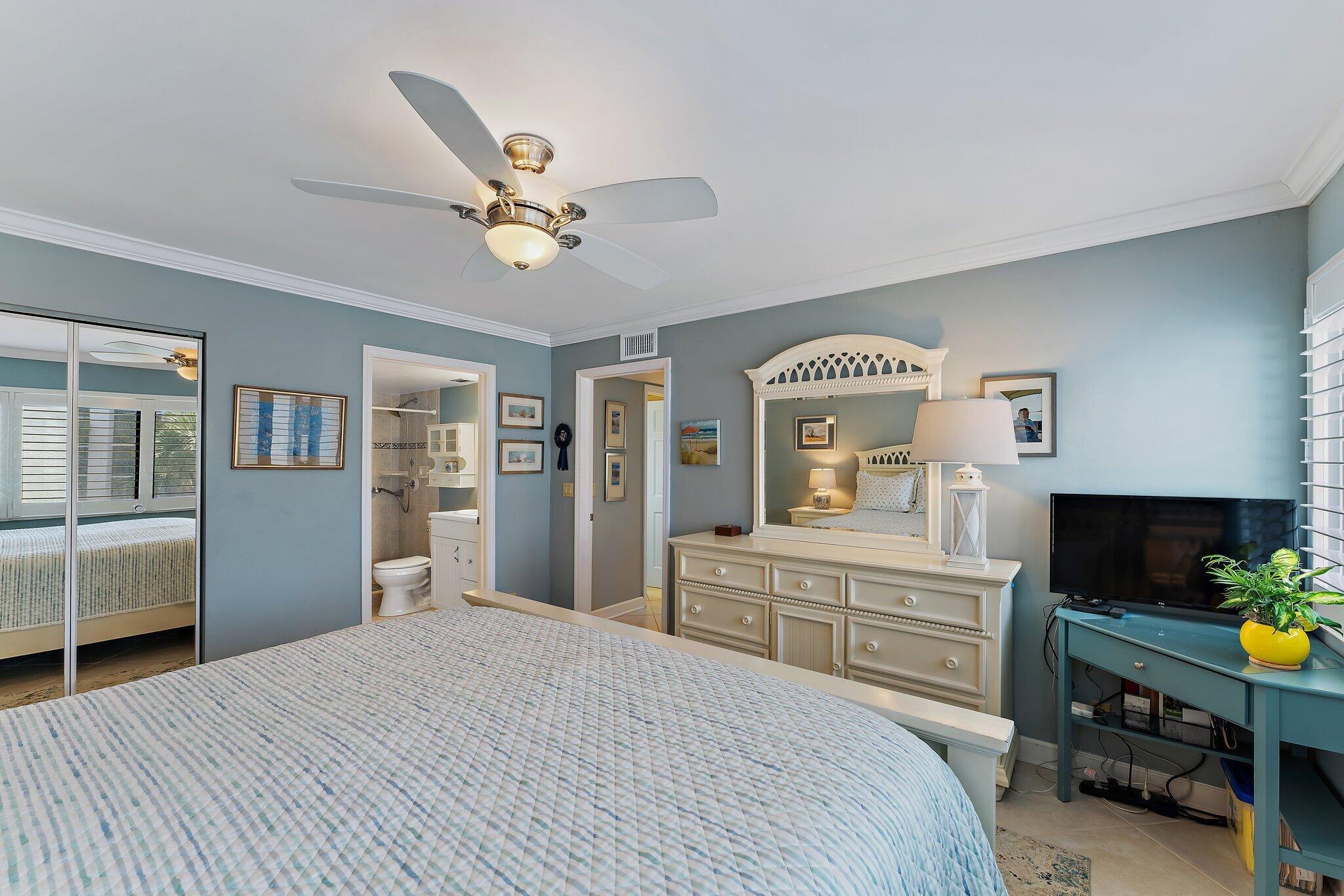 1605 Us-1, Unit B206 Jupiter, FL 33477 - Photo 26 of 35 a bedroom with a bed dresser and a window