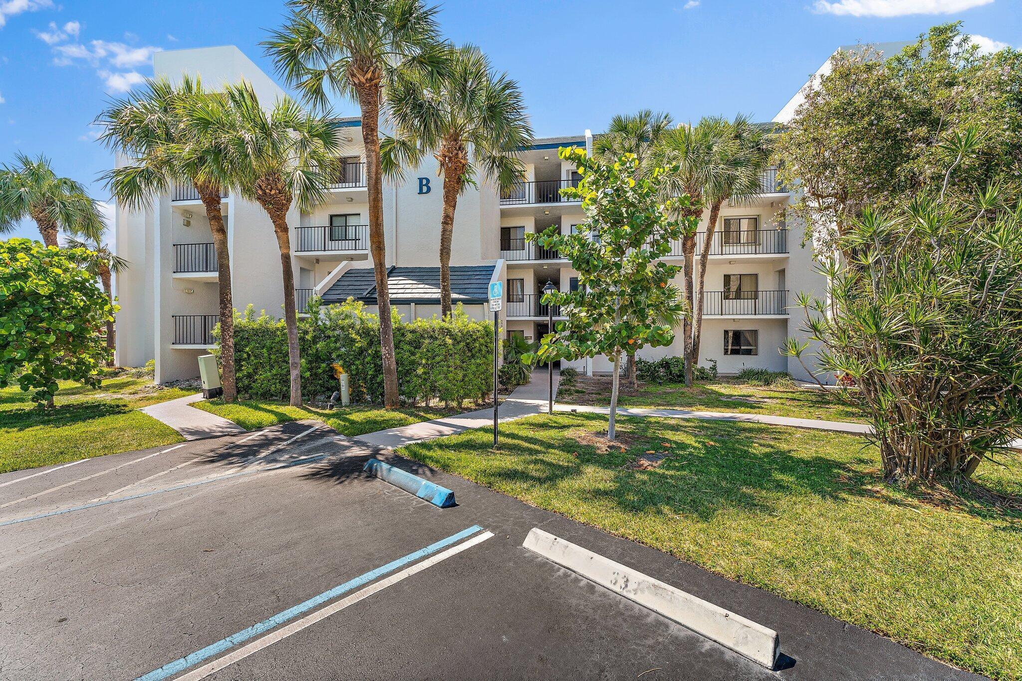 1605 Us-1, Unit B206 Jupiter, FL 33477 - Photo 33 of 35 a house with palm tree in front of it