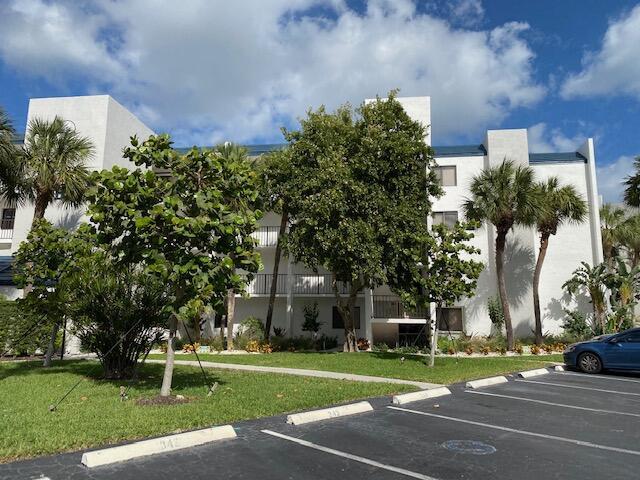 1605 Us-1, Unit B206 Jupiter, FL 33477 - Photo 4 of 35 a front view of a house with a yard and a garage