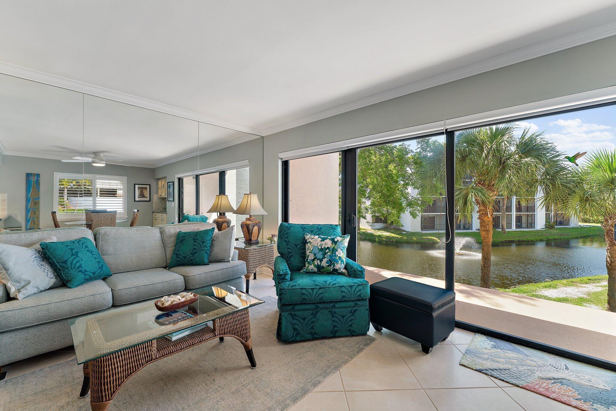 1605 Us-1, Unit B206 Jupiter, FL 33477 - Photo 8 of 35 a living room with furniture and a large window