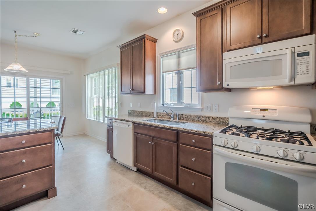 5536 Republic Way Bethlehem, PA 18017 - Photo 8 of 34 a kitchen with stainless steel appliances granite countertop a stove a sink and a microwave