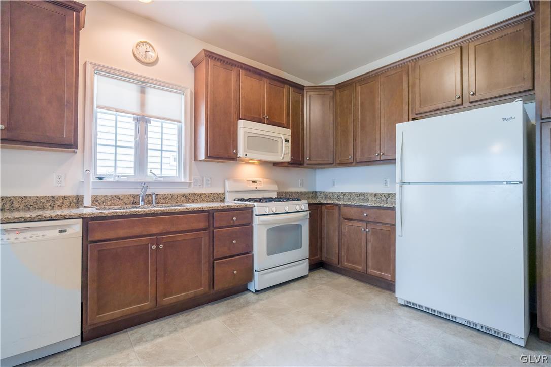 5536 Republic Way Bethlehem, PA 18017 - Photo 9 of 34 a kitchen with granite countertop a refrigerator sink stove and microwave