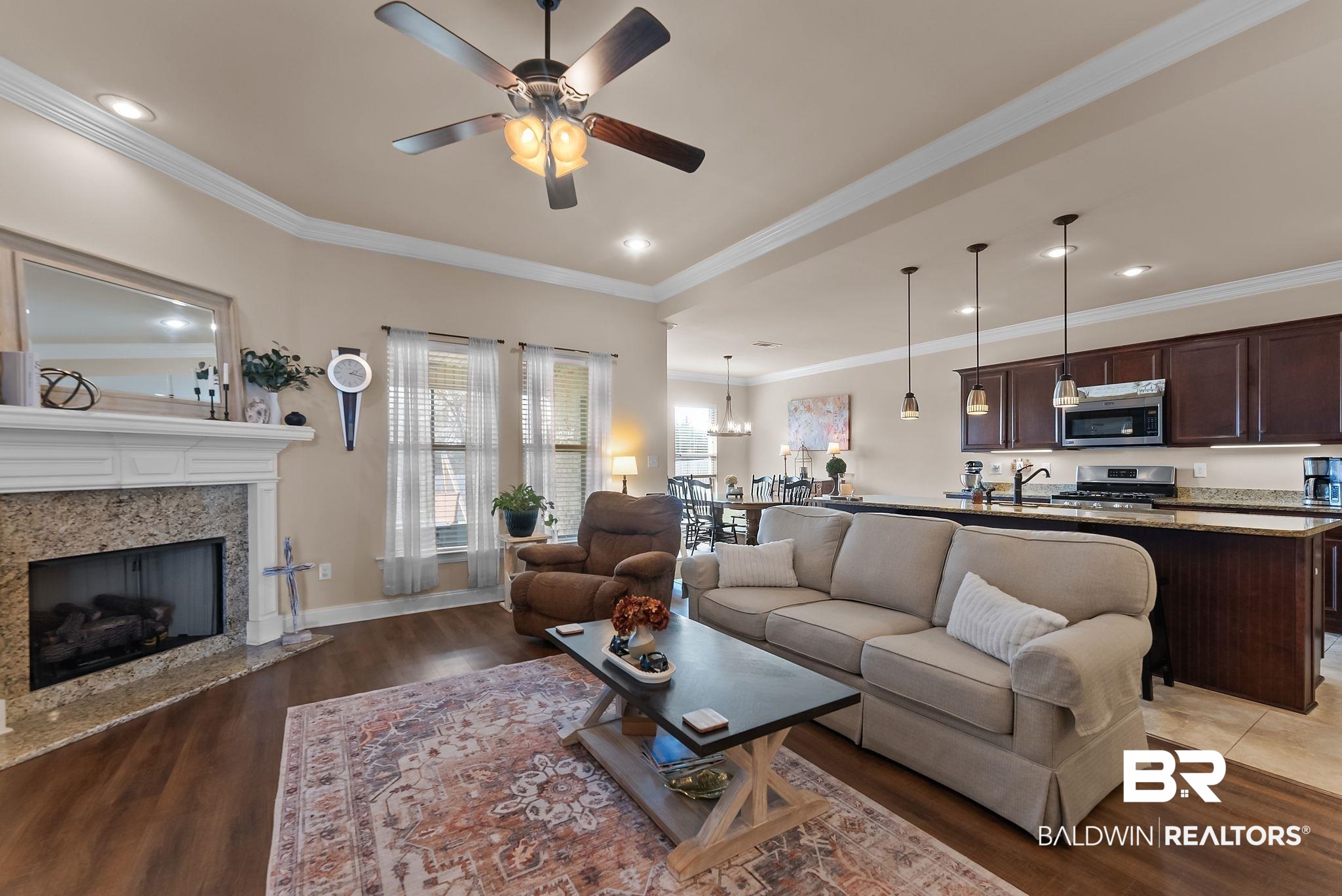 7015 Rocky Rd Loop Gulf Shores, AL 36542 - Photo 11 of 41 Living room with a ceiling fan, light wood-type flooring, ornamental molding, and a premium fireplace