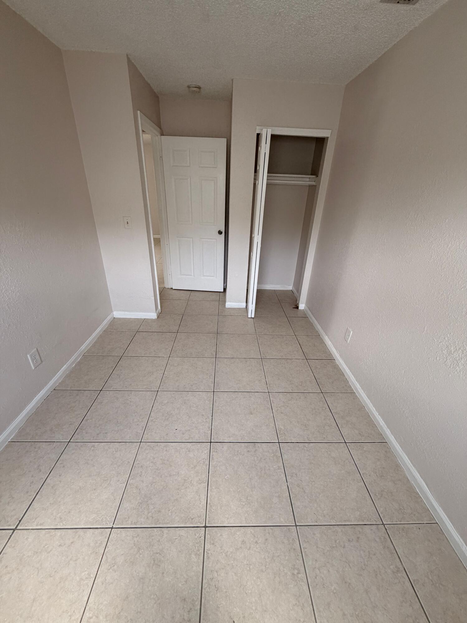 1618 West 26th Court, Unit A Riviera Beach, FL 33404 - Photo 13 of 15 a view of an empty room and closet area