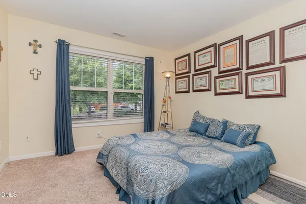 a bedroom with a bed and a large window