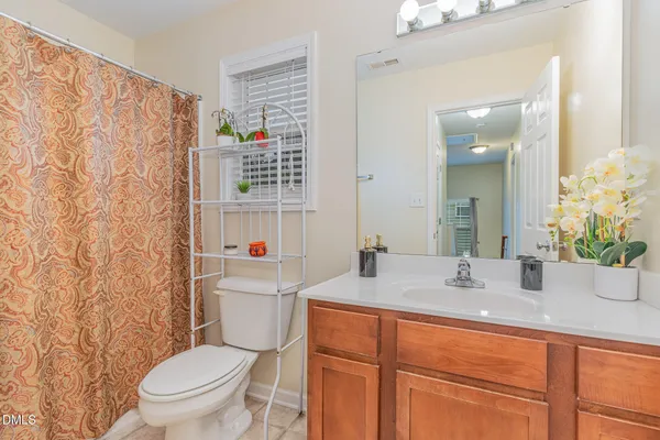 a bathroom with a sink toilet vanity and tub