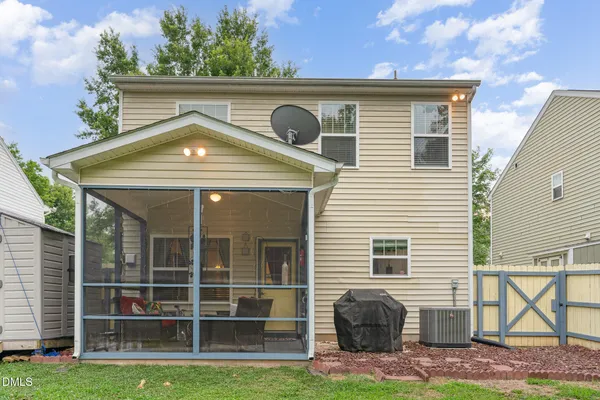 a front view of a house with plants and garage
