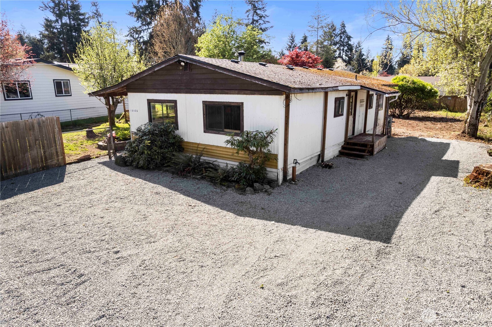13125 Ridge Circle East Bonney Lake, WA 98391 - Photo 2 of 15 a view of a house with a yard covered in snow