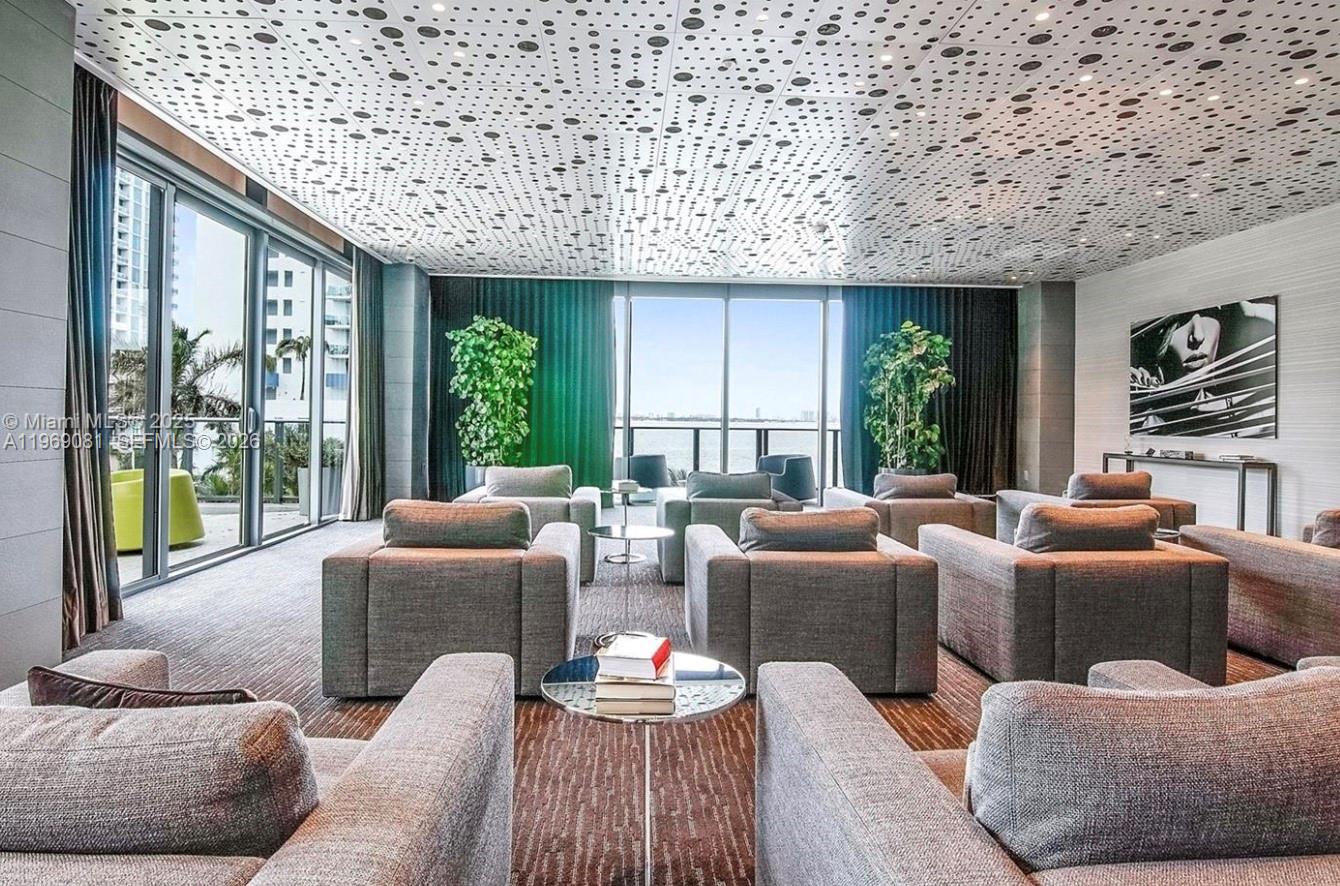 460 Northeast 28th Street, Unit 2102 Miami, FL 33137 - Photo 11 of 14 a living room with furniture and a large window