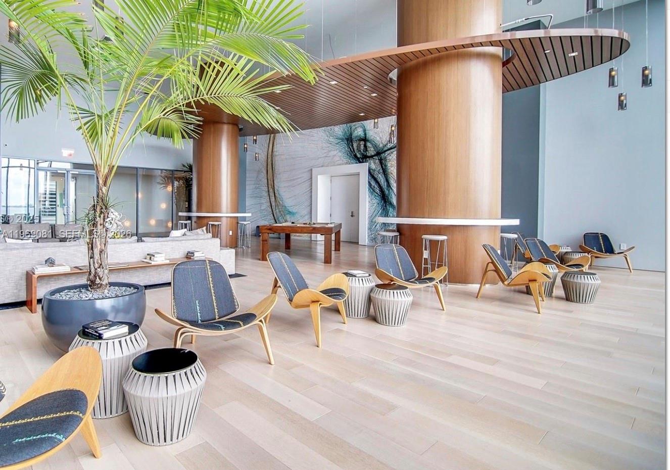 460 Northeast 28th Street, Unit 2102 Miami, FL 33137 - Photo 3 of 14 a living room with furniture and a potted plant