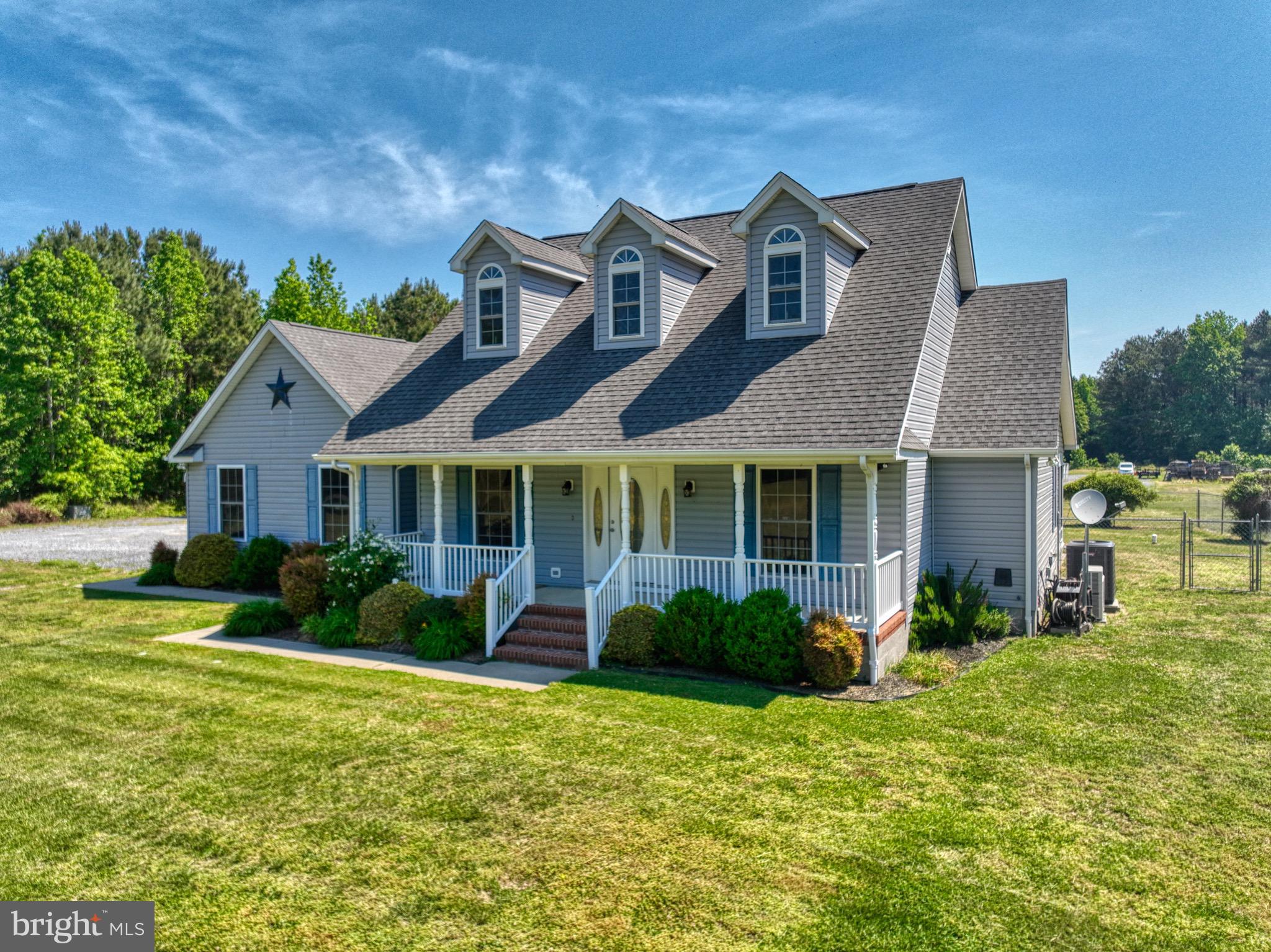 18315 Atlanta Road Bridgeville, DE 19933 - Photo 1 of 28 a front view of a house with garden