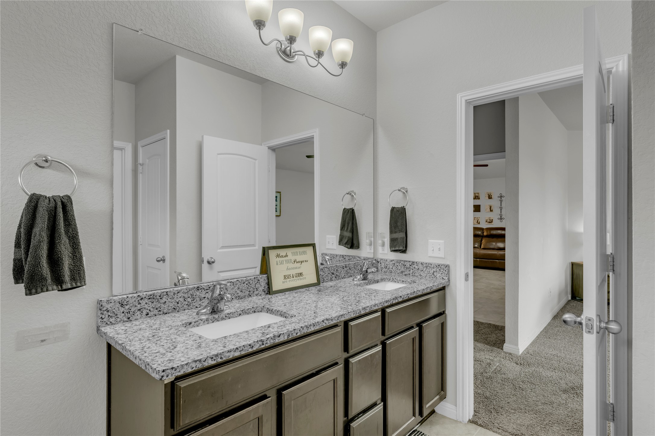 132 Cinnamon Loop Burnet, TX 78611 - Photo 14 of 27 Bathroom featuring a dual vanity with a granite countertop, undermount sinks, and a full-width mirror