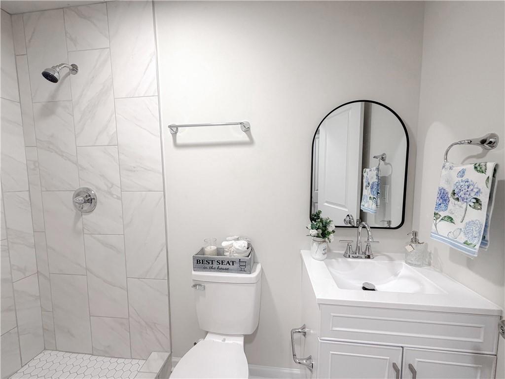 102 Welch Street Stockbridge, GA 30281 - Photo 12 of 28 a bathroom with a sink toilet and shower