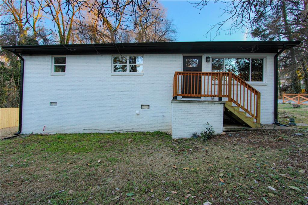 102 Welch Street Stockbridge, GA 30281 - Photo 27 of 28 a view of a small house with wooden fence