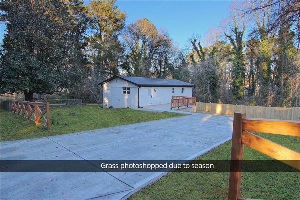 102 Welch Street Stockbridge, GA 30281 - Photo 3 of 28 a view of house with backyard and trees