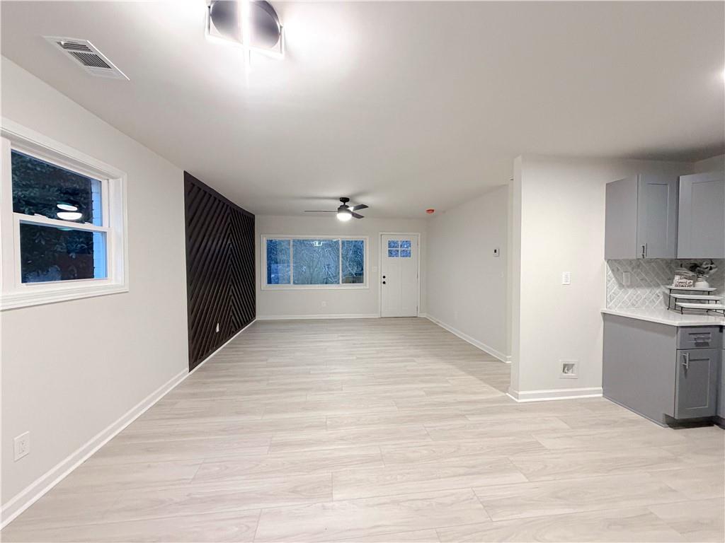 102 Welch Street Stockbridge, GA 30281 - Photo 5 of 28 a view of an empty room with a kitchen