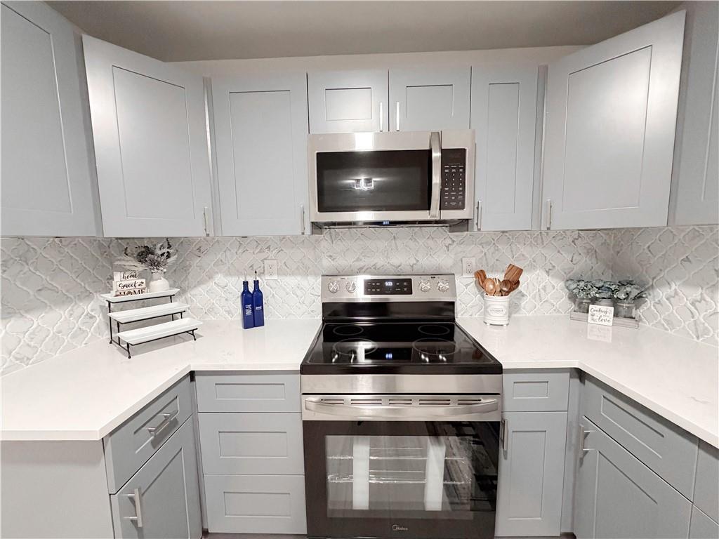 102 Welch Street Stockbridge, GA 30281 - Photo 9 of 28 a kitchen with a stove and a microwave