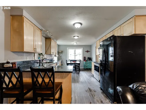 a kitchen with sink and refrigerator