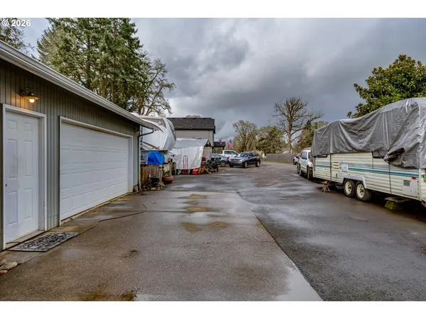 a backyard of a house with wooden deck and barbeque oven