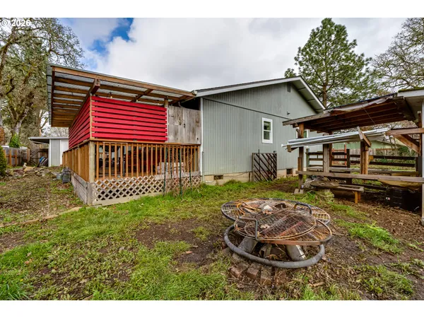a backyard of a house with yard and trampoline