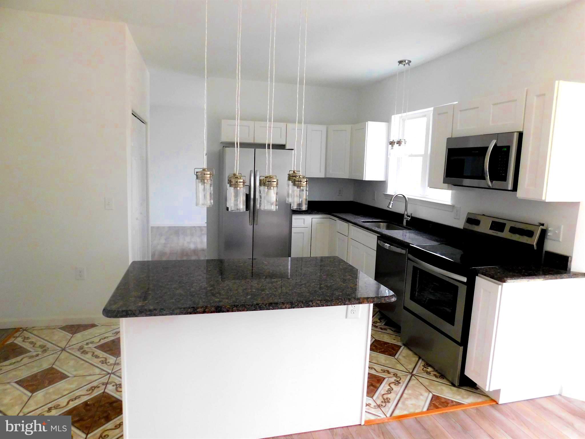 2 Whaleys Road Delmar, DE 19940 - Photo 12 of 28 a kitchen with stainless steel appliances granite countertop a sink stove and refrigerator