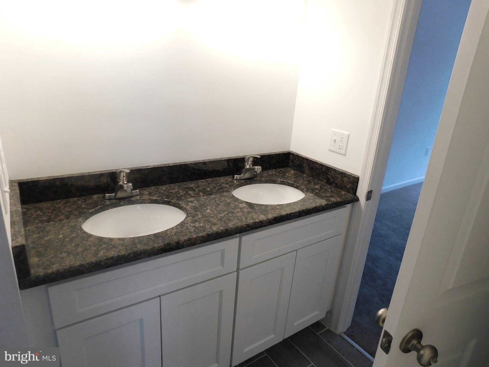 2 Whaleys Road Delmar, DE 19940 - Photo 16 of 28 a bathroom with a granite countertop sink and a mirror