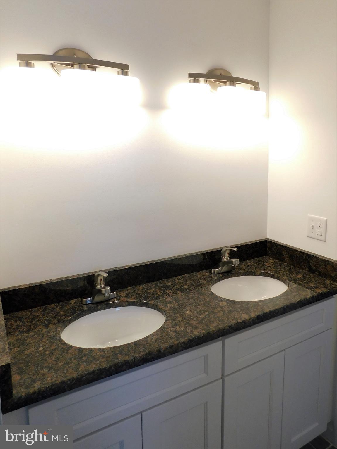 2 Whaleys Road Delmar, DE 19940 - Photo 17 of 28 a bathroom with a granite countertop sink and a mirror