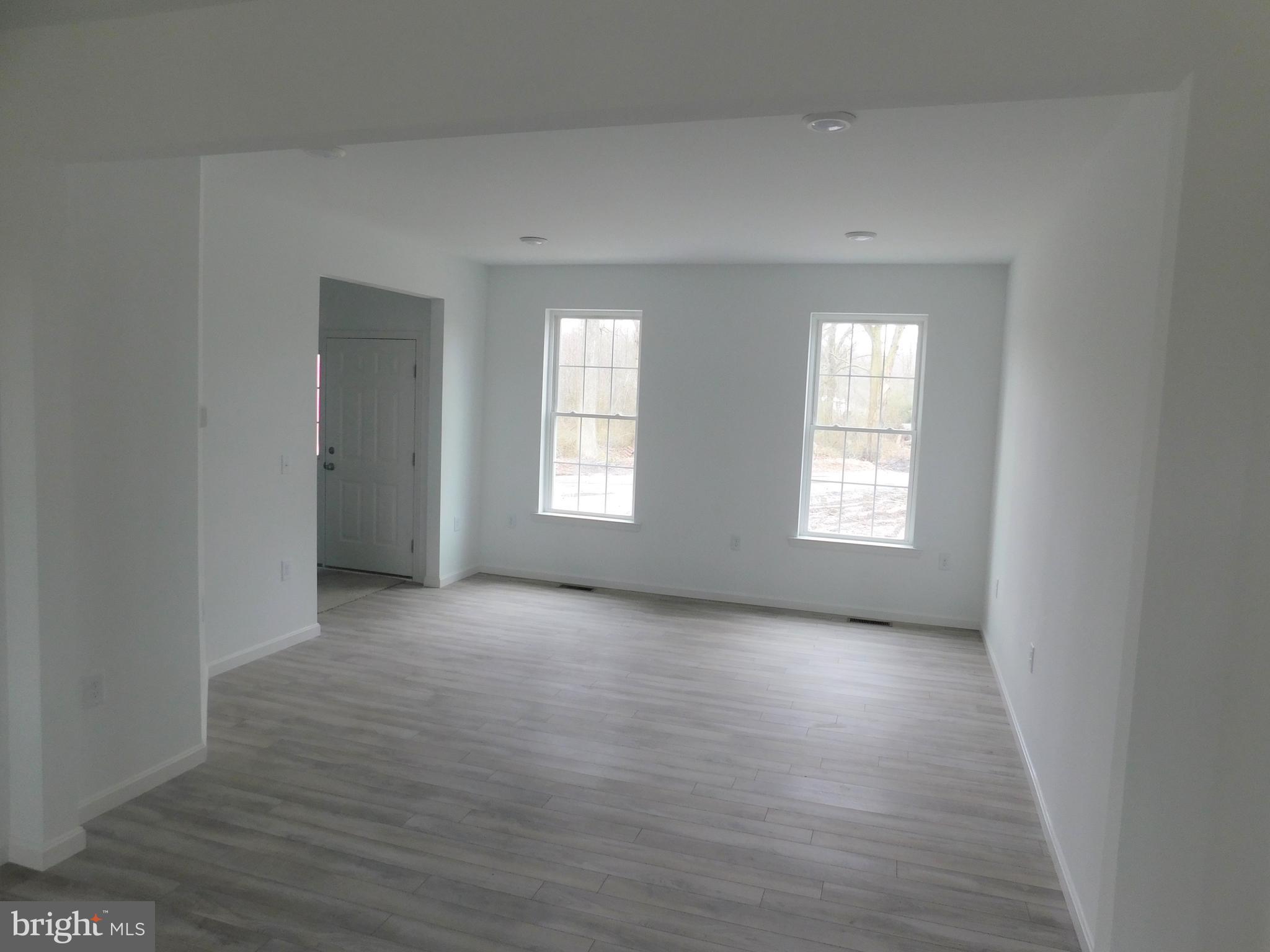 2 Whaleys Road Delmar, DE 19940 - Photo 7 of 28 an empty room with wooden floor and windows
