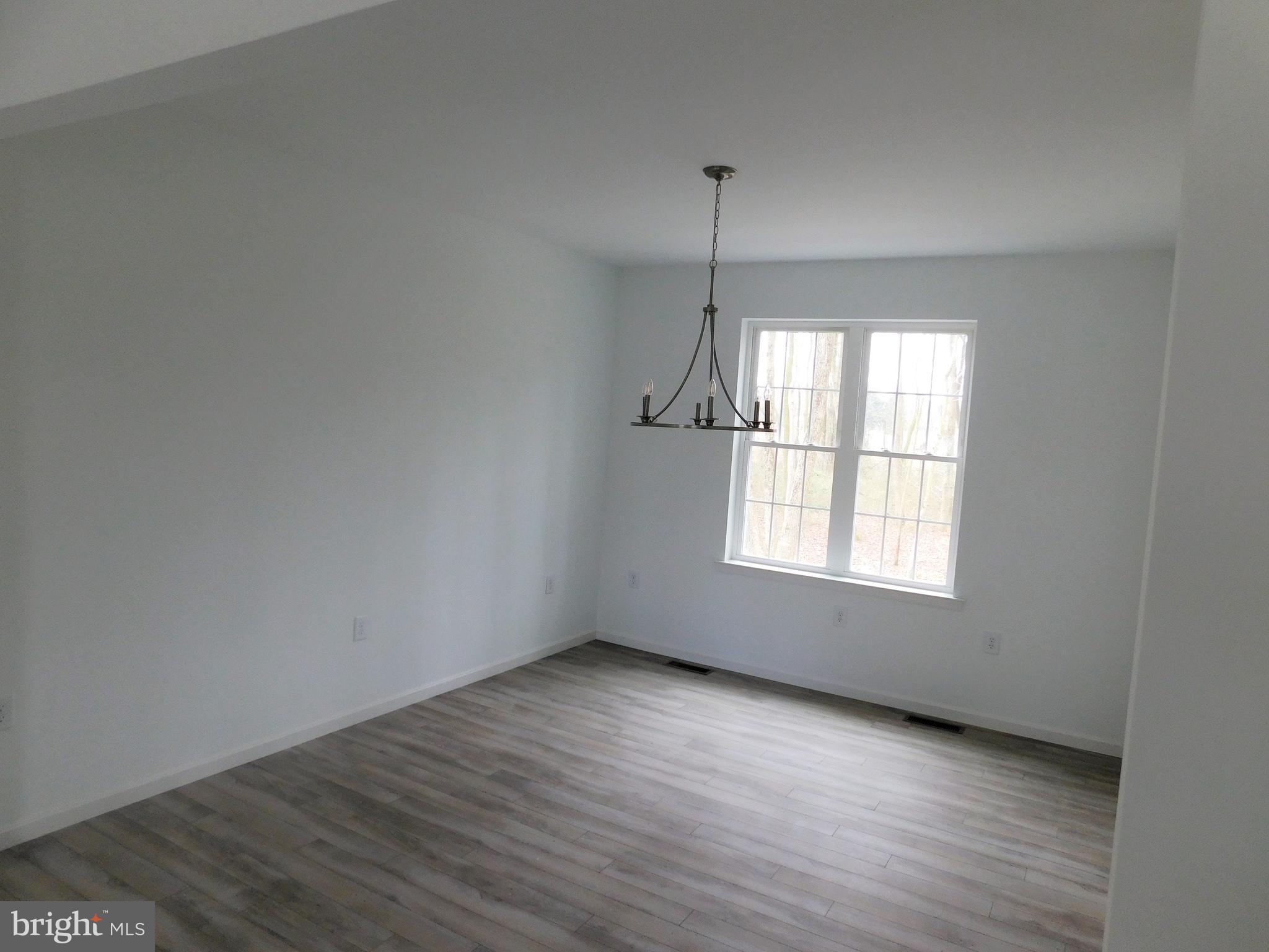 2 Whaleys Road Delmar, DE 19940 - Photo 9 of 28 an empty room with wooden floor and windows
