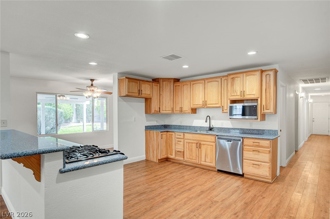 1810 Pinto Road Henderson, NV 89002 - Photo 19 of 53 A well-appointed kitchen showcasing light wood cabinetry and a convenient gas range on a breakfast bar.