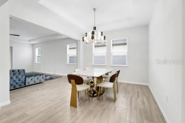 a view of a dining room with furniture and wooden floor