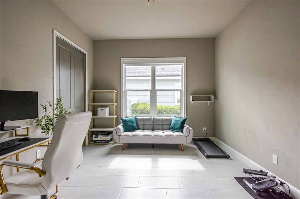 11967 Southwest 32nd Lane Gainesville, FL 32608 - Photo 11 of 22 a living room with furniture and a flat screen tv