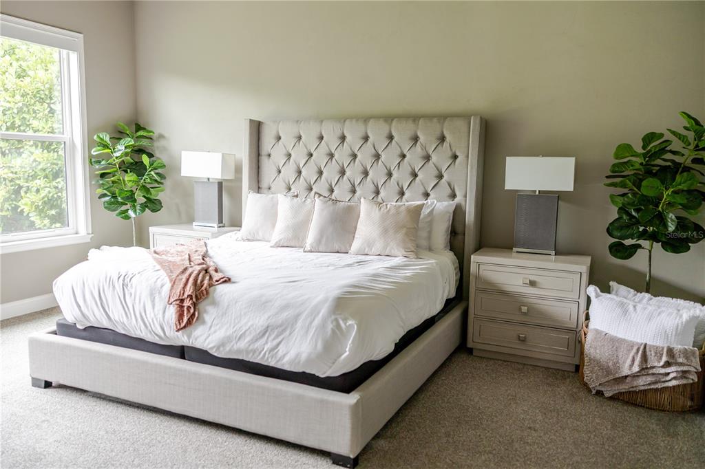 11967 Southwest 32nd Lane Gainesville, FL 32608 - Photo 2 of 22 a bedroom with a bed and a potted plant