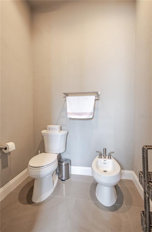 11967 Southwest 32nd Lane Gainesville, FL 32608 - Photo 3 of 22 a white toilet sitting next to a bathroom sink