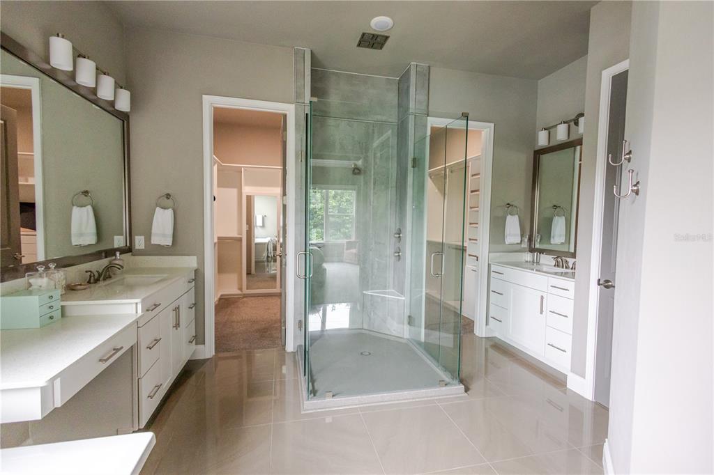 11967 Southwest 32nd Lane Gainesville, FL 32608 - Photo 8 of 22 a spacious bathroom with a shower a sink and a mirror