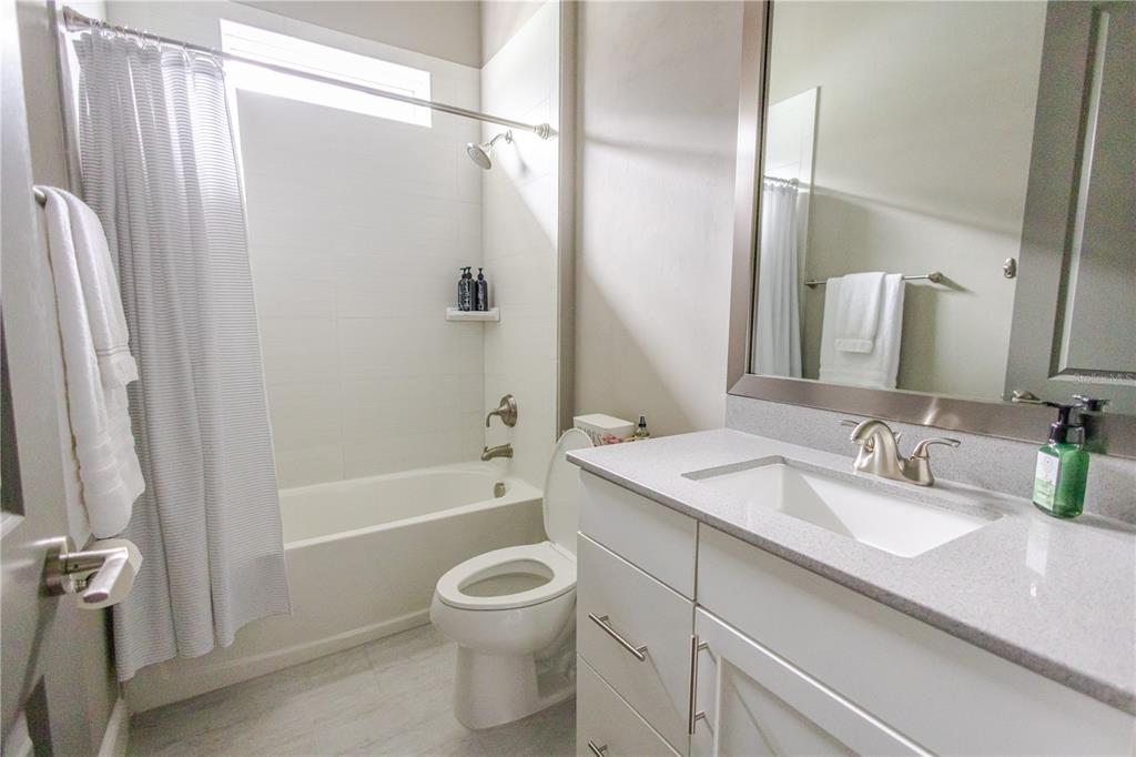 11967 Southwest 32nd Lane Gainesville, FL 32608 - Photo 10 of 22 a bathroom with a granite countertop sink toilet and shower