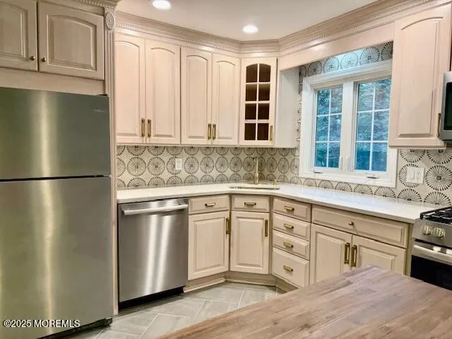 a kitchen with stainless steel appliances granite countertop a refrigerator sink and cabinets