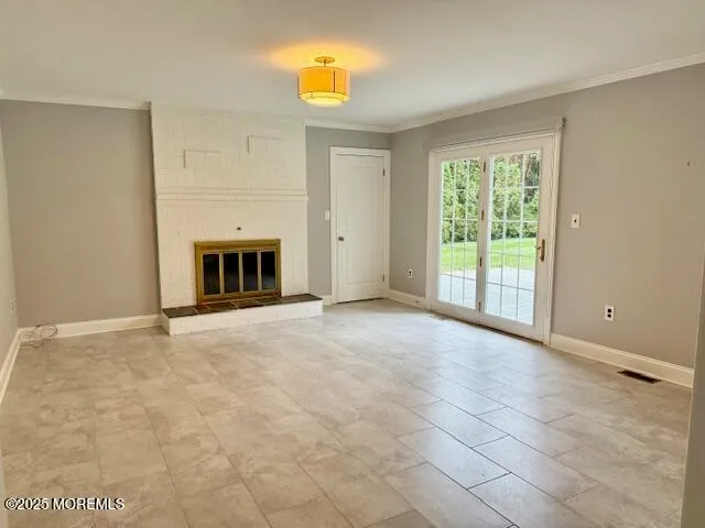 a view of empty room with a fireplace