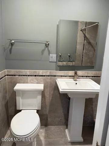 a bathroom with a sink mirror vanity and toilet