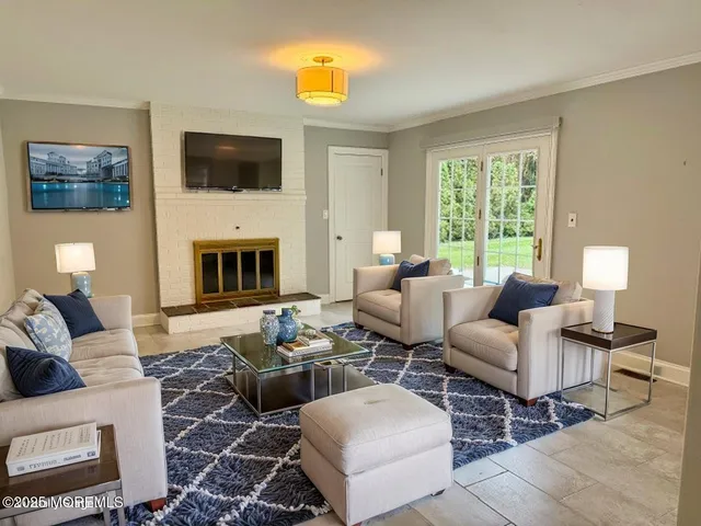 a living room with furniture a fireplace and a flat screen tv
