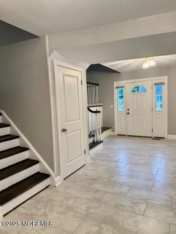 a view of a livingroom with wooden floor and stairs