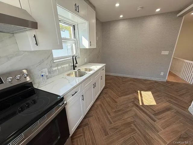 a kitchen with a sink stove and cabinets