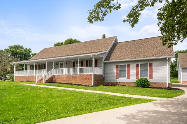 a front view of house with yard and green space