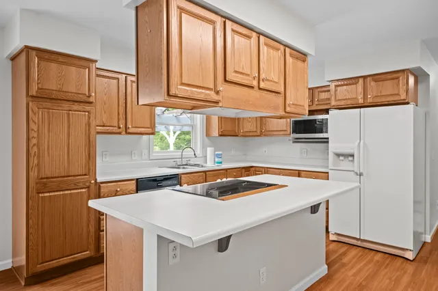 a kitchen with stainless steel appliances a refrigerator sink and cabinets