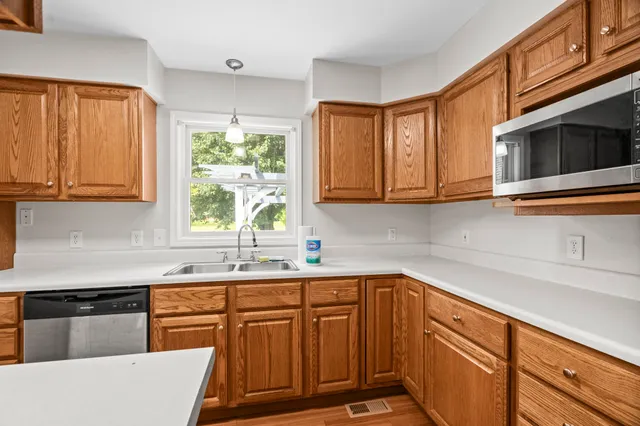 a kitchen with stainless steel appliances granite countertop a sink stove and microwave