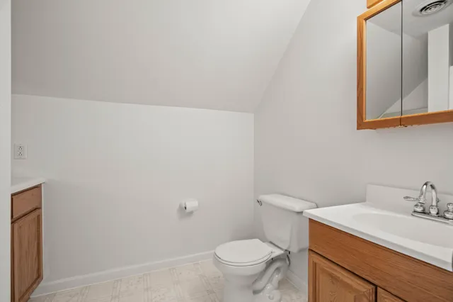 a bathroom with a sink toilet and vanity