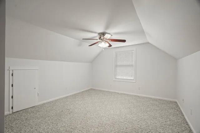 a view of a room with window and ceiling fan